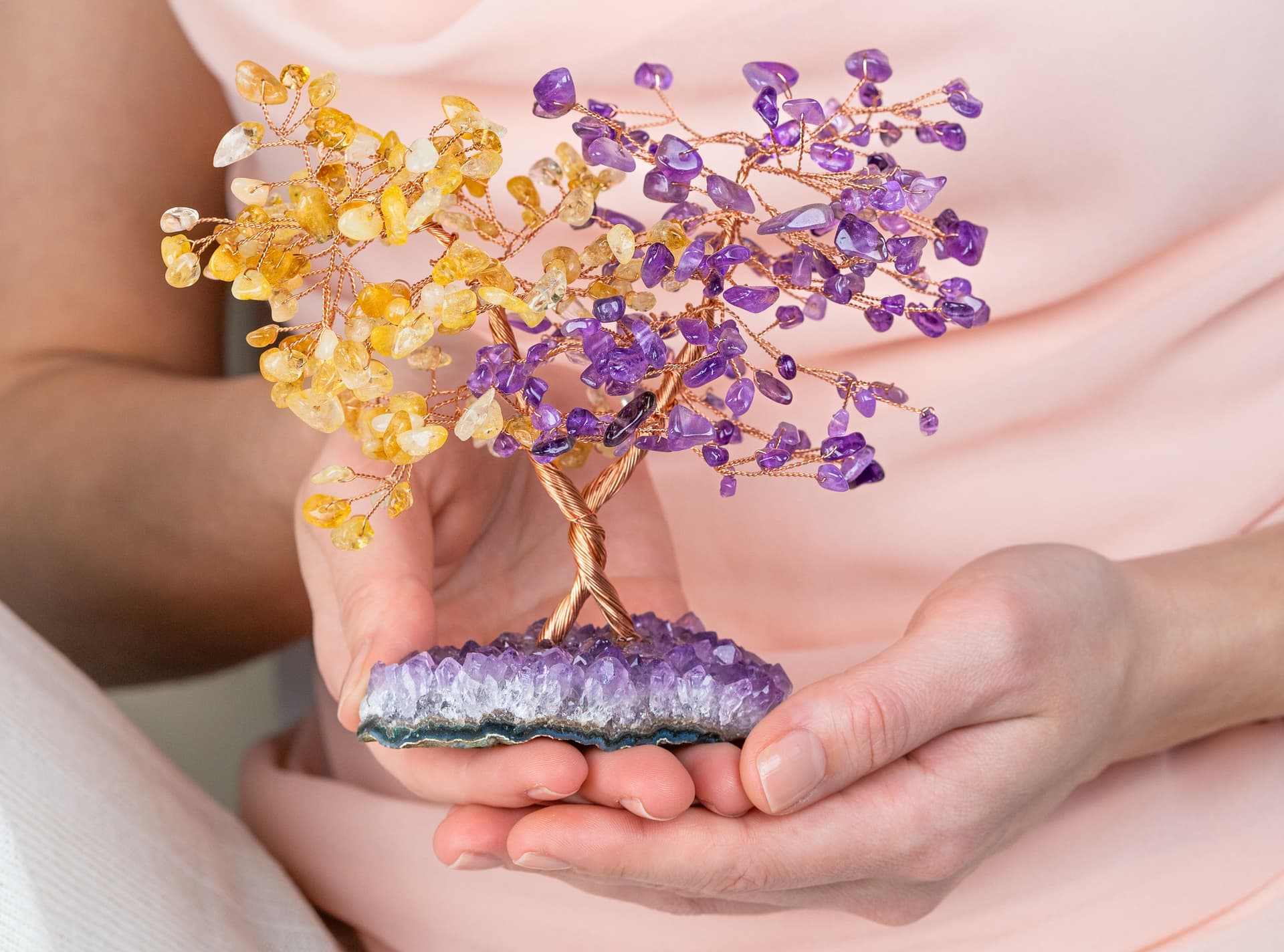 Amethyst and citrine crystals placed among  stones.